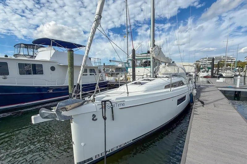 Coastal Distancing Yacht Photos Pics 2021 Beneteau Oceanis 30.1 sailboat docked at marina under blue sky.