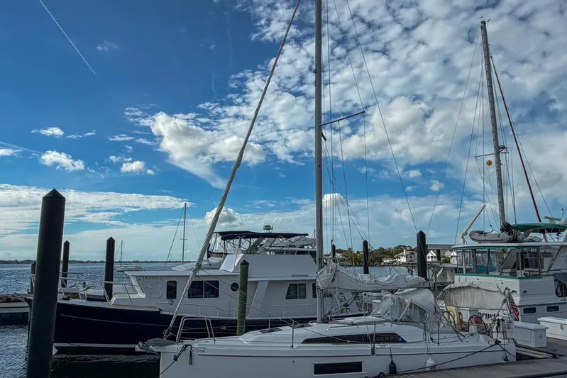 Coastal Distancing Yacht Photos Pics Beneteau Oceanis 30.1 sailboat docked at marina under blue sky, 2021 model.
