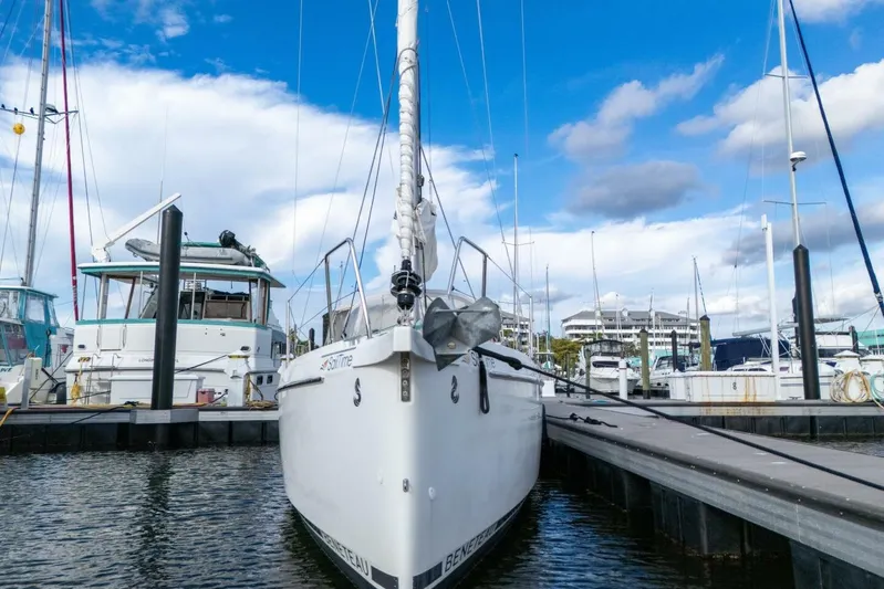 Coastal Distancing Yacht Photos Pics 2021 Beneteau Oceanis 30.1 sailboat docked at marina under blue sky.