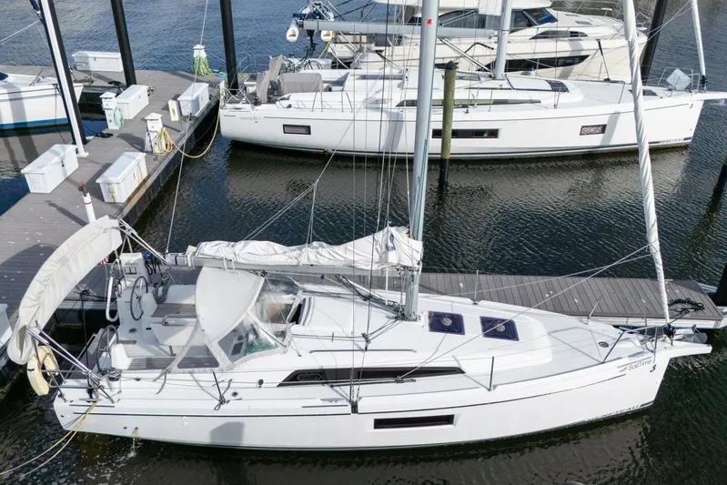 Coastal Distancing Yacht Photos Pics 2021 Beneteau Oceanis 30.1 sailboat docked at marina, aerial view.