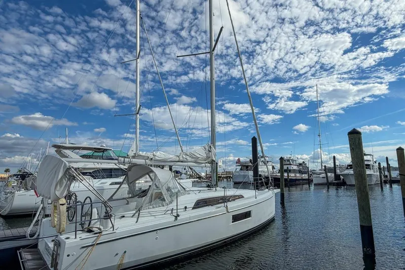 Coastal Distancing Yacht Photos Pics Beneteau Oceanis 30.1 sailboat docked at marina under blue sky, 2021 model.