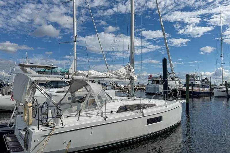 Coastal Distancing Yacht Photos Pics 2021 Beneteau Oceanis 30.1 sailboat docked at marina under blue sky.