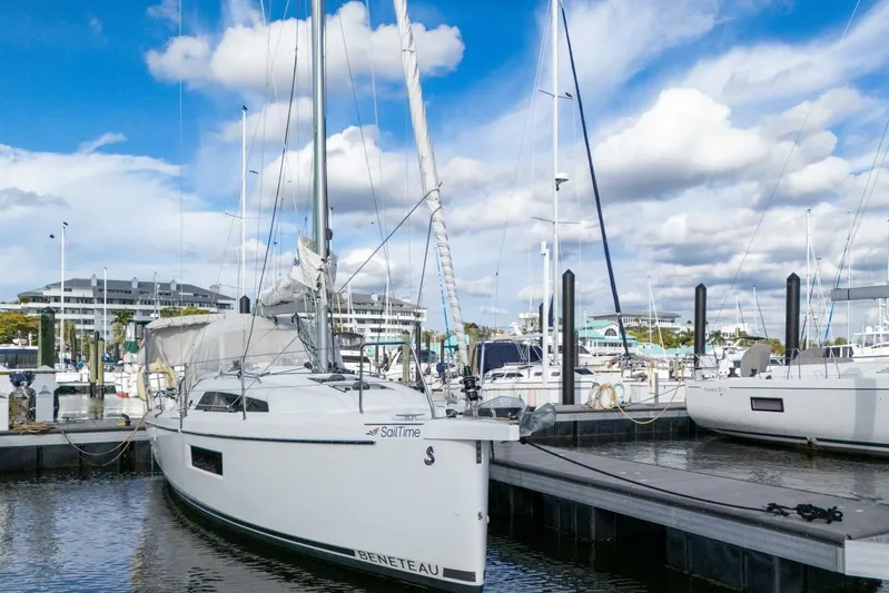 Coastal Distancing Yacht Photos Pics 2021 Beneteau Oceanis 30.1 sailboat docked at marina under blue sky.