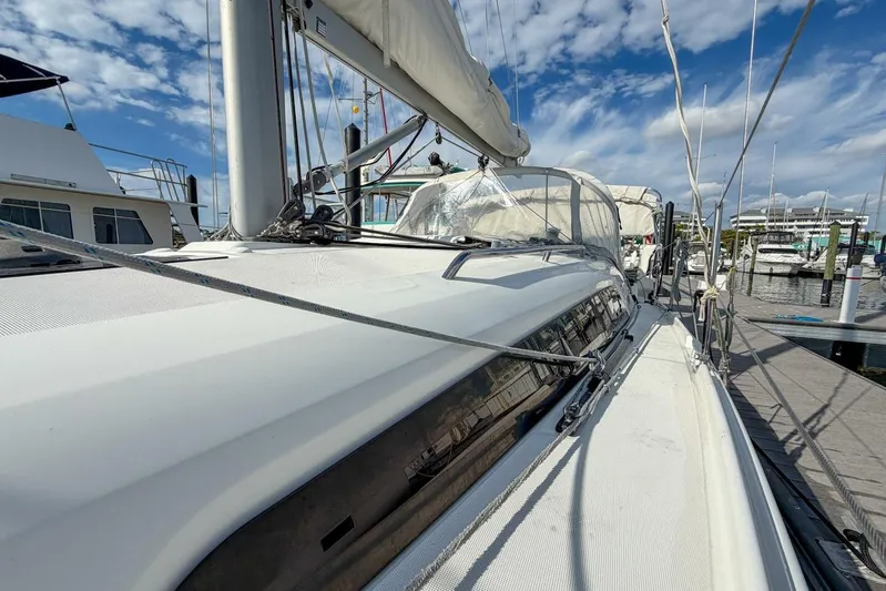 Coastal Distancing Yacht Photos Pics 2021 Beneteau Oceanis 30.1 sailboat docked at marina under blue sky.