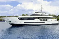 Luxury yacht Custom Line CL106, 2023 model, cruising on calm waters under a partly cloudy sky.