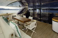 Luxurious 2023 Custom Line CL106 yacht deck with elegant seating and scenic ocean view.