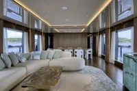 Luxurious interior of 2023 Custom Line CL106 yacht with modern furnishings and panoramic windows.