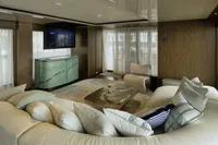 Luxurious yacht interior with plush seating, modern decor, and a flat-screen TV, Custom Line CL106, 2023.