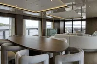 Luxurious interior of 2023 Custom Line CL106 yacht with elegant dining and seating area.