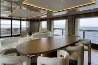 Luxurious yacht interior with ocean view, featuring elegant dining area, Custom Line CL106, 2023 model.