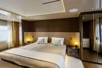 Luxurious bedroom in 2023 Custom Line CL106 yacht with ocean view and modern decor.