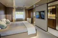 Luxurious bedroom interior on Custom Line CL106 yacht, featuring modern design and scenic window view.