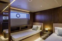 Luxurious twin cabin interior of 2023 Custom Line CL106 yacht, featuring modern design and ambient lighting.