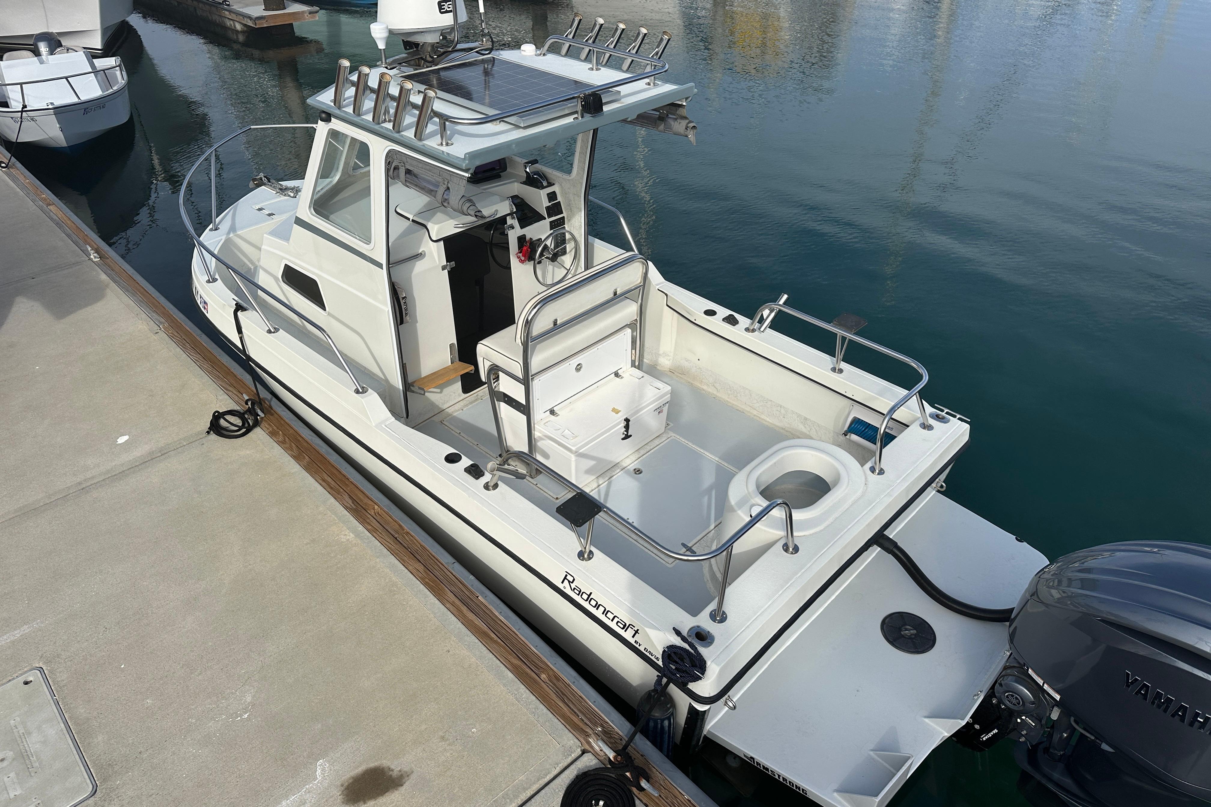 1993 Davis Radoncraft boat docked at marina, featuring spacious deck and modern design.