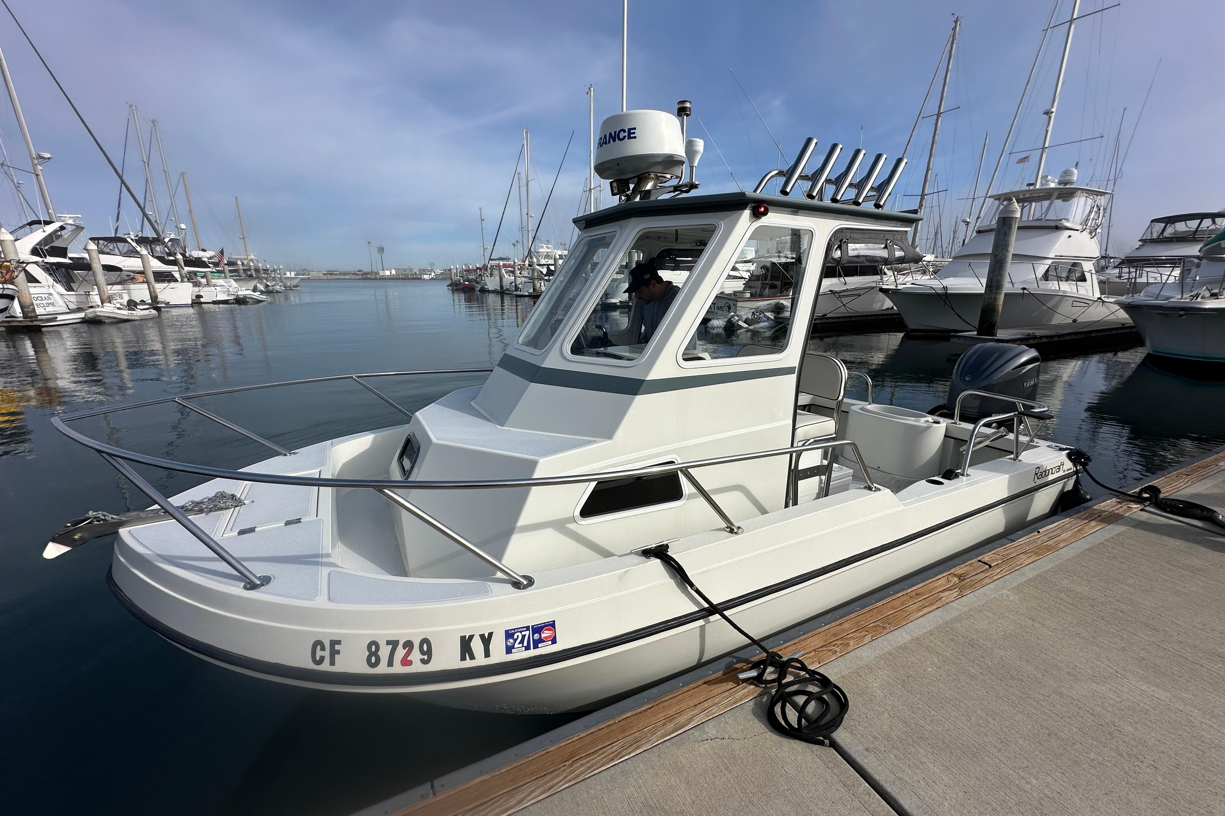 1993 Davis Radoncraft boat docked at marina, surrounded by other vessels.