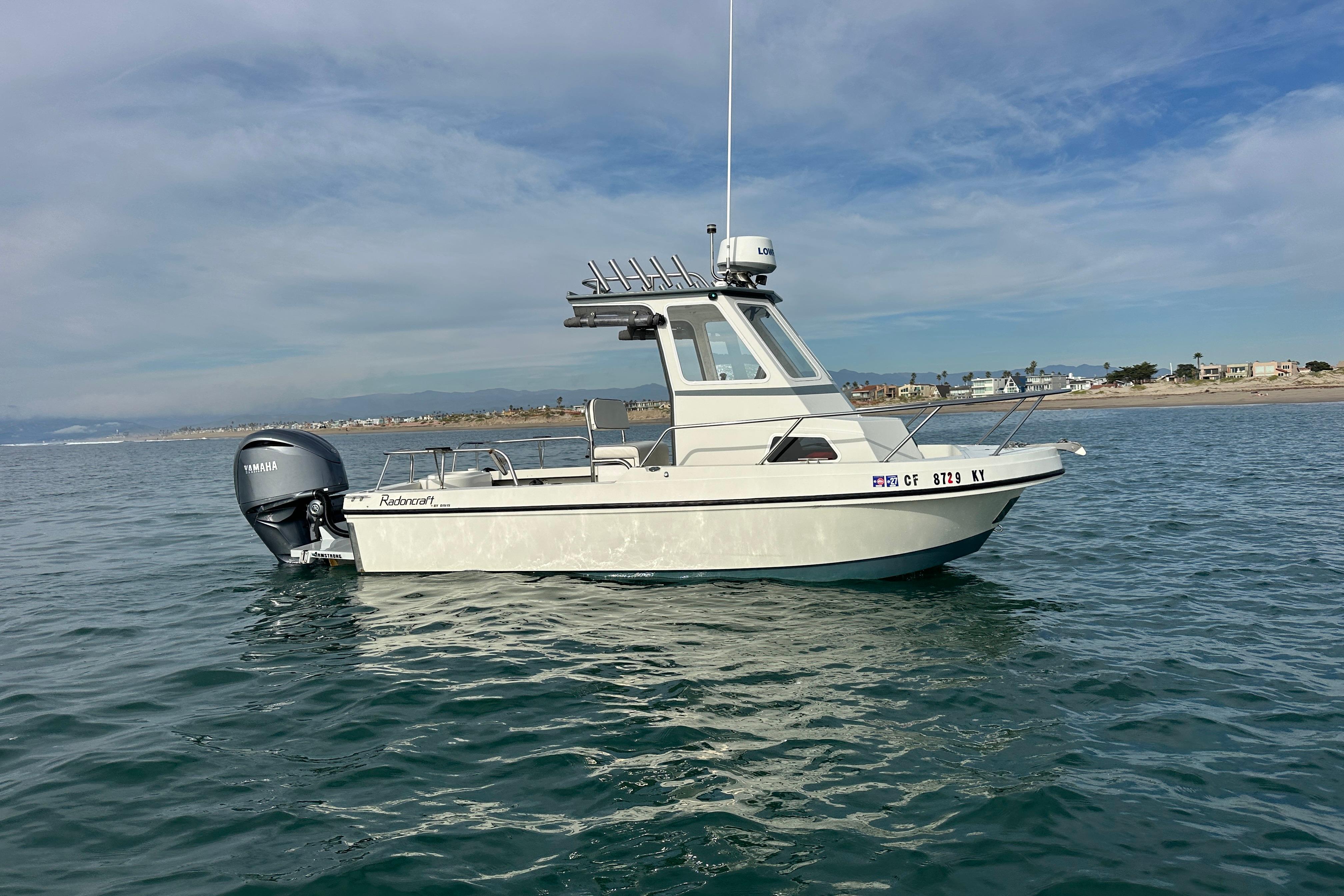 1993 Davis Radoncraft boat on calm water with Yamaha outboard motor.