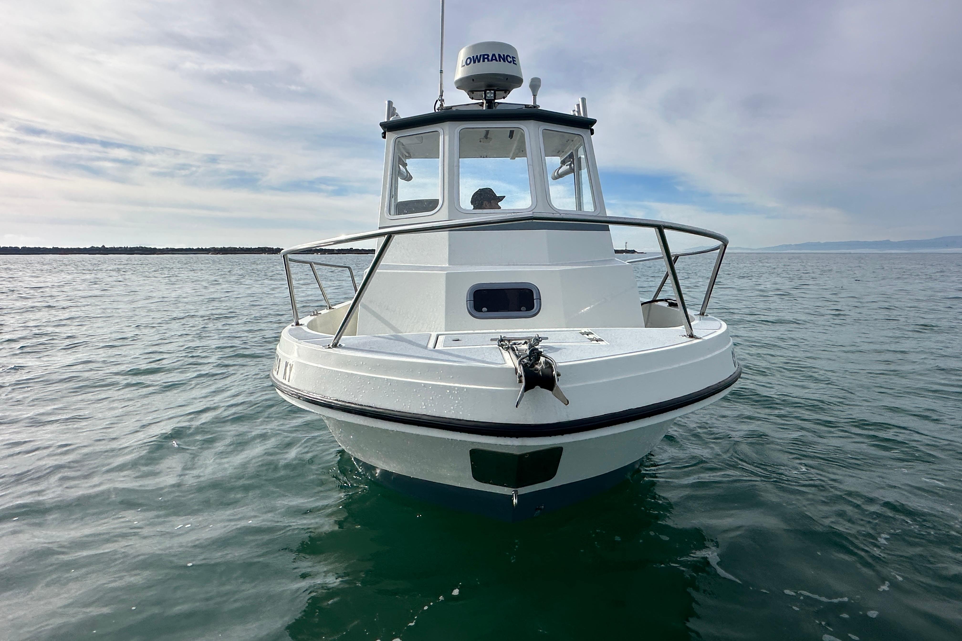 1993 Davis Radoncraft boat on calm water under cloudy sky.