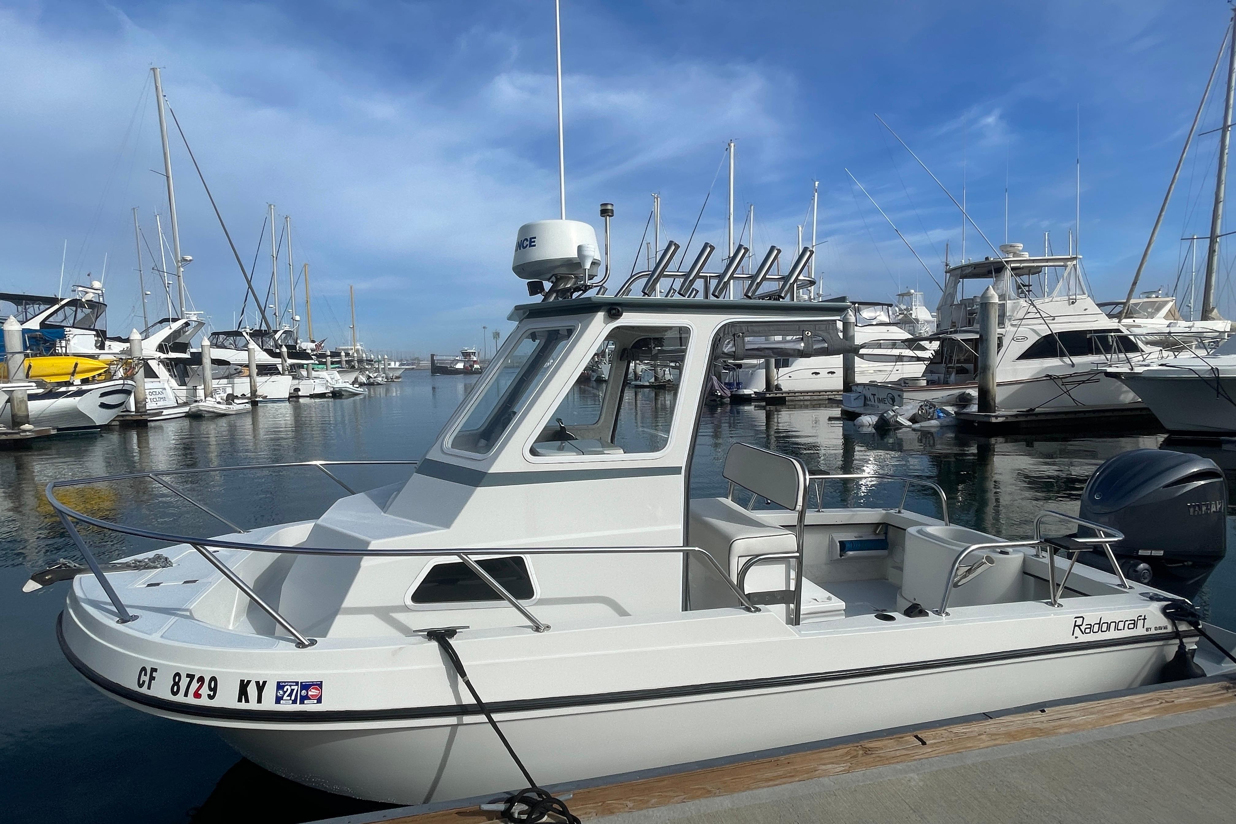 1993 Davis Radoncraft boat docked at a marina, surrounded by other vessels.
