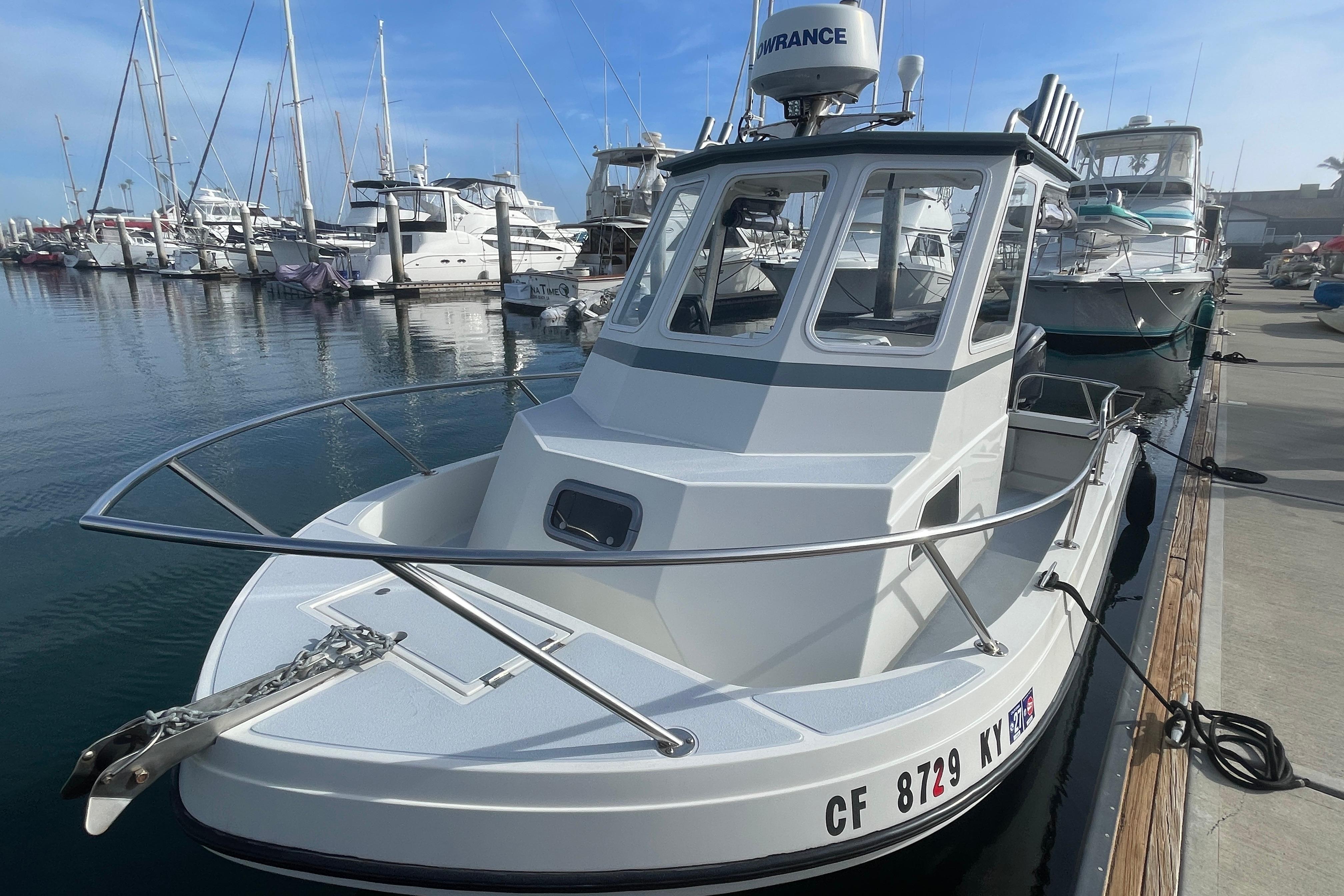 1993 Davis Radoncraft boat docked at marina with other vessels in background.
