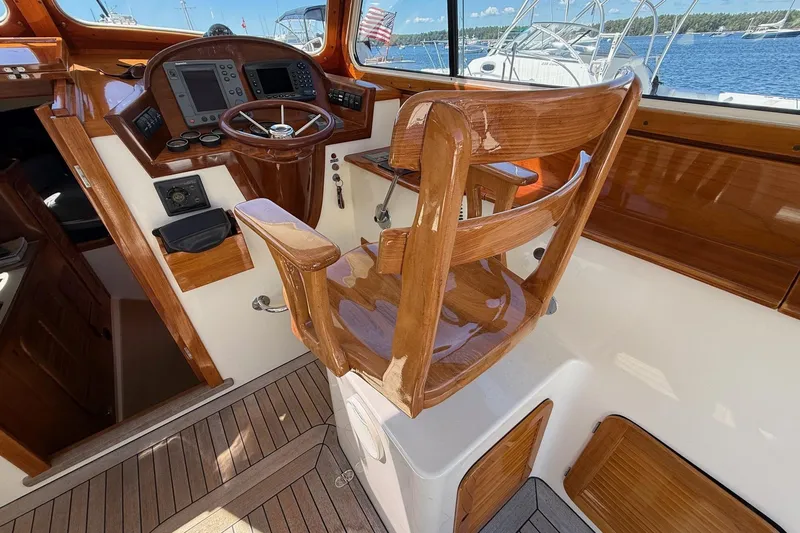 Timothy E Yacht Photos Pics 2001 Hinckley Classic Picnic Boat helm with polished wood and modern navigation equipment.