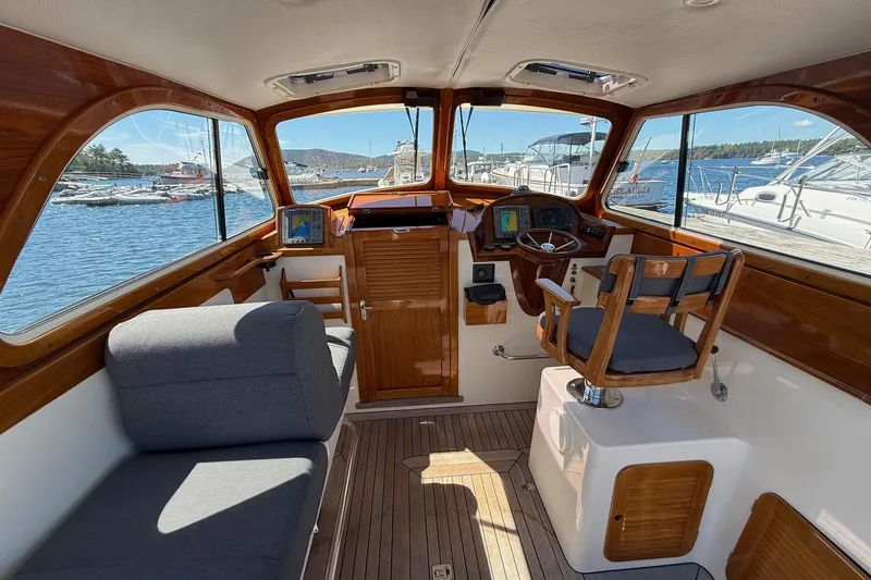 Timothy E Yacht Photos Pics Interior of a 2001 Hinckley Classic Picnic Boat with wooden accents and nautical views.