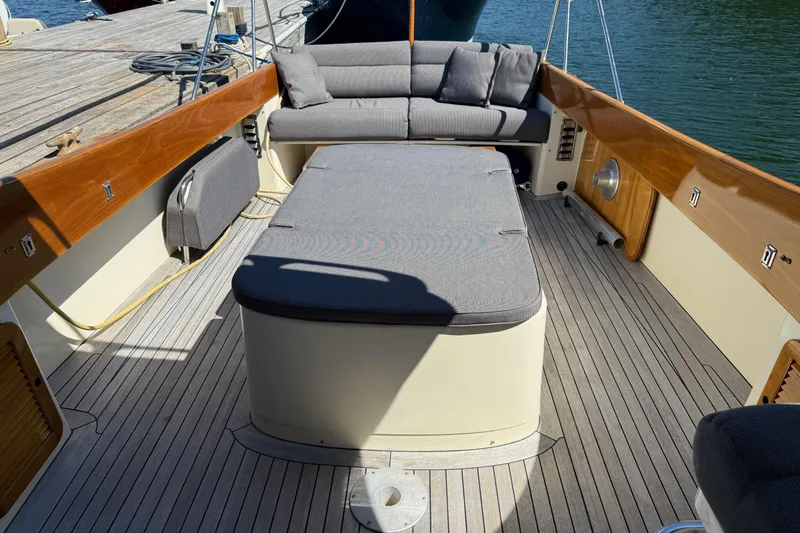 Timothy E Yacht Photos Pics 2001 Hinckley Classic Picnic Boat interior with cushioned seating and wooden deck.