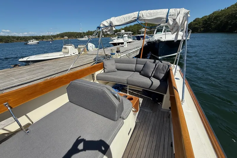 Timothy E Yacht Photos Pics 2001 Hinckley Classic Picnic Boat docked, featuring elegant seating and wooden accents.