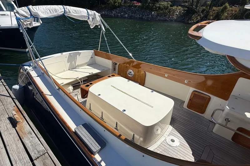 Timothy E Yacht Photos Pics 2001 Hinckley Classic Picnic Boat docked, featuring elegant wood trim and spacious seating area.