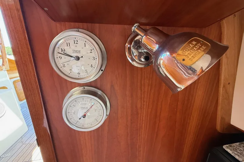 Timothy E Yacht Photos Pics Hinckley Classic Picnic Boat 2001 interior with clock, barometer, and brass light fixture.