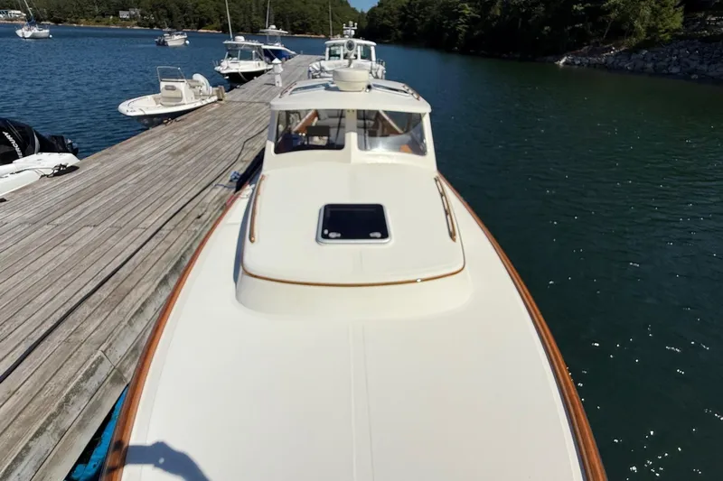 Timothy E Yacht Photos Pics 2001 Hinckley Classic Picnic Boat docked on calm water, surrounded by other boats.