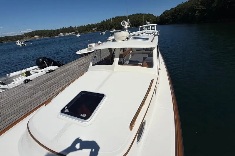 Timothy E Yacht Photos Pics 2001 Hinckley Classic Picnic Boat docked on serene waters, showcasing elegant design.