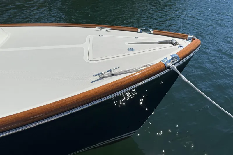 Timothy E Yacht Photos Pics 2001 Hinckley Classic Picnic Boat bow with teak accents on calm water.