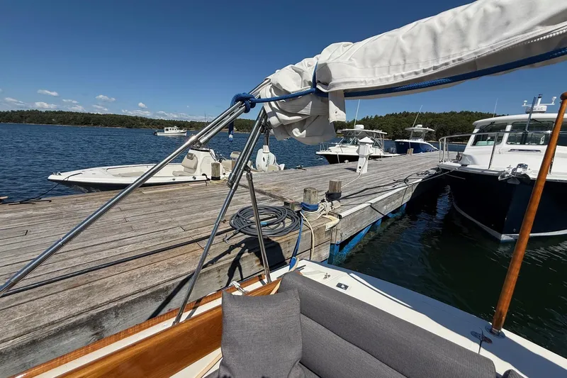 Timothy E Yacht Photos Pics Hinckley Classic Picnic Boat 2001 docked at a scenic marina with clear blue skies.