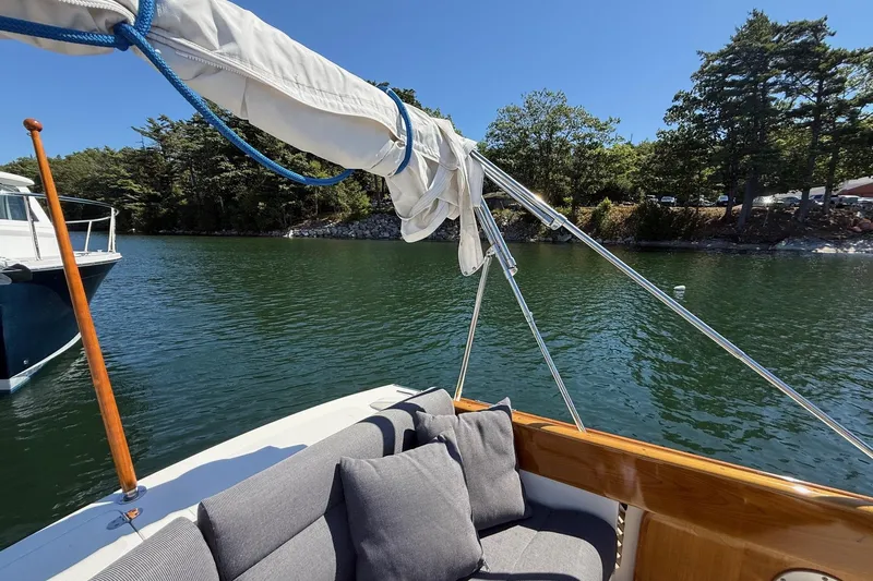 Timothy E Yacht Photos Pics 2001 Hinckley Classic Picnic Boat on serene water, surrounded by lush trees.