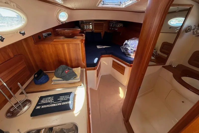 Timothy E Yacht Photos Pics 2001 Hinckley Classic Picnic Boat interior with wood finish and cozy seating area.