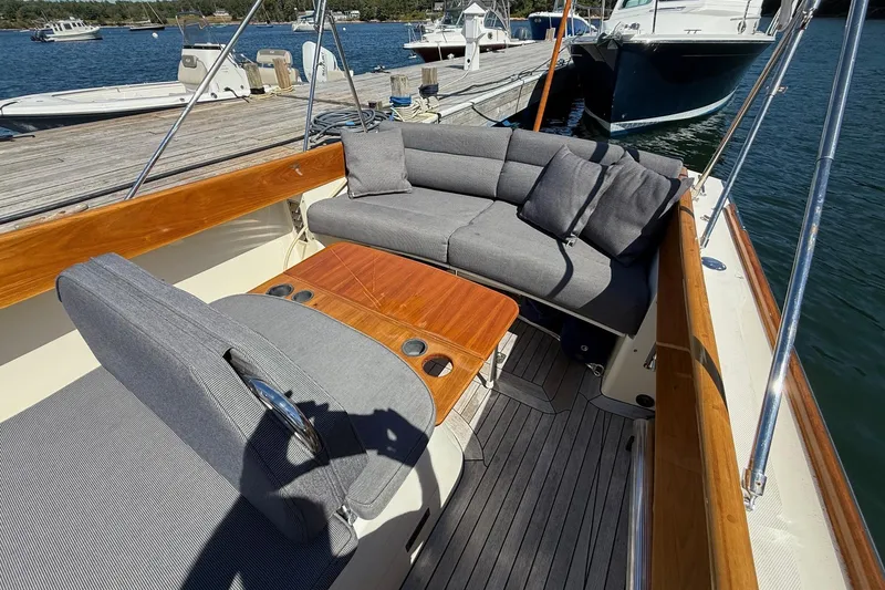 Timothy E Yacht Photos Pics 2001 Hinckley Classic Picnic Boat with elegant seating and wooden table, docked by the water.