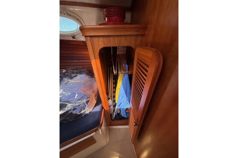 Timothy E Yacht Photos Pics 2001 Hinckley Classic Picnic Boat interior with wooden closet and hanging clothes.