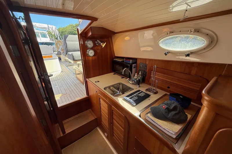 Timothy E Yacht Photos Pics Interior of 2001 Hinckley Classic Picnic Boat with kitchenette and seating area.