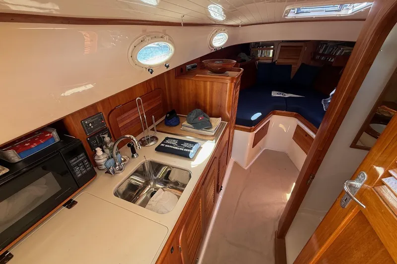 Timothy E Yacht Photos Pics 2001 Hinckley Classic Picnic Boat interior with kitchenette and cozy seating area.