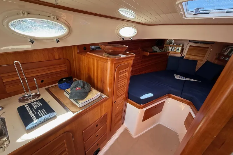 Timothy E Yacht Photos Pics Interior of 2001 Hinckley Classic Picnic Boat with wood finish and cozy seating area.