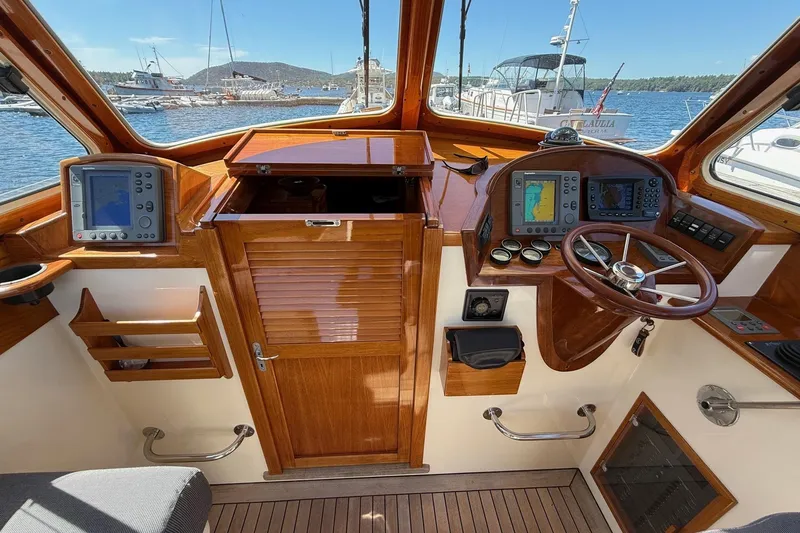 Timothy E Yacht Photos Pics 2001 Hinckley Classic Picnic Boat cockpit with wooden dashboard and navigation equipment.