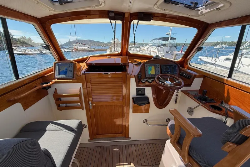 Timothy E Yacht Photos Pics 2001 Hinckley Classic Picnic Boat interior with wooden helm and navigation equipment.
