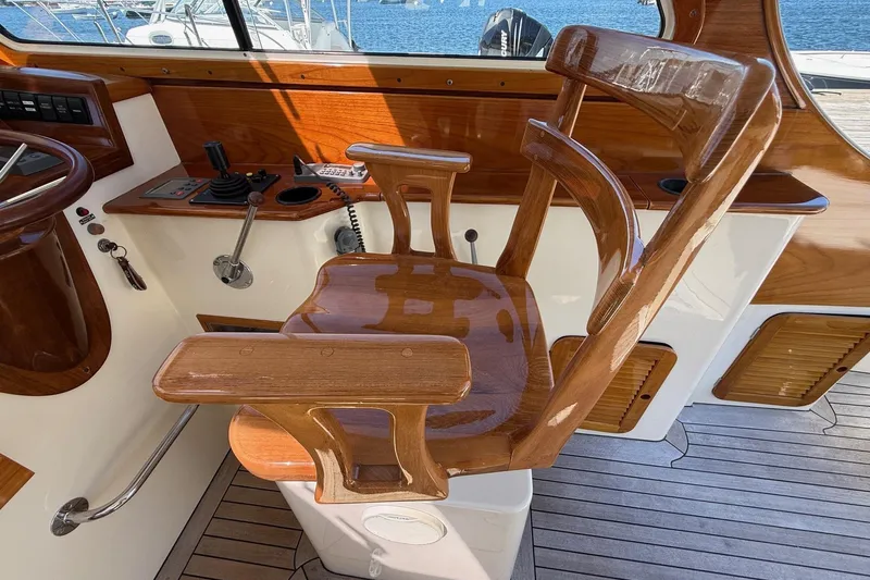 Timothy E Yacht Photos Pics Wooden helm chair on 2001 Hinckley Classic Picnic Boat, showcasing elegant craftsmanship.