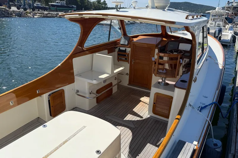 Timothy E Yacht Photos Pics 2001 Hinckley Classic Picnic Boat with wooden interior, docked by the water.