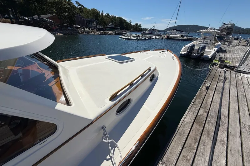 Timothy E Yacht Photos Pics 2001 Hinckley Classic Picnic Boat docked at a scenic marina.