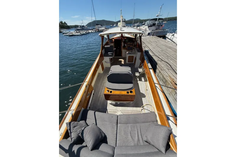 Timothy E Yacht Photos Pics 2001 Hinckley Classic Picnic Boat docked, featuring elegant wooden deck and comfortable seating.