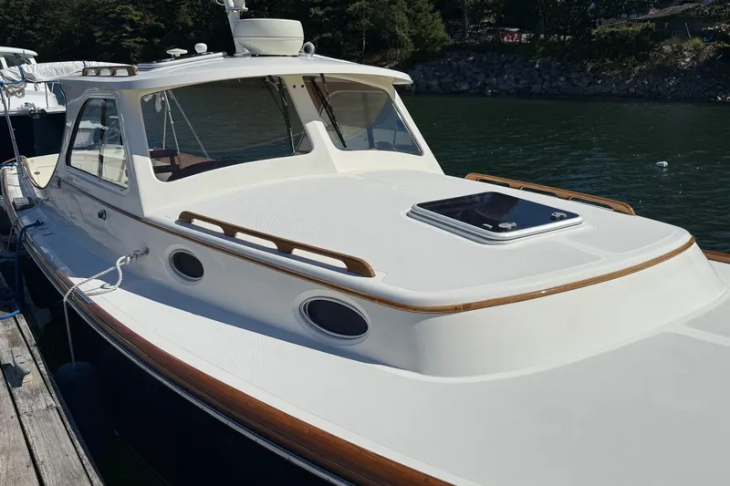 Timothy E Yacht Photos Pics 2001 Hinckley Classic Picnic Boat docked on calm water, showcasing elegant design and craftsmanship.