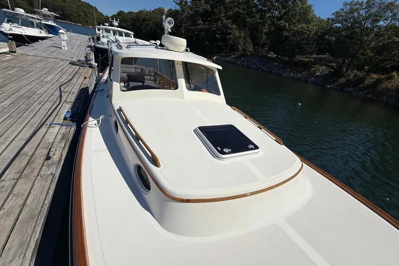 Timothy E Yacht Photos Pics 2001 Hinckley Classic Picnic Boat docked by a wooden pier on a sunny day.