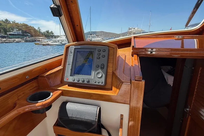 Timothy E Yacht Photos Pics 2001 Hinckley Classic Picnic Boat interior with navigation system, wooden finish, and marina view.