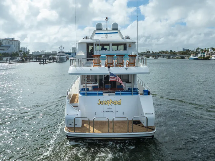 Jusmad Yacht Photos Pics Ocean Alexander 80 yacht from 2005 on water, rear view with American flag.